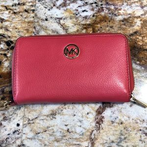 Michael kors wristlet. Coral in color. 6 inches long 3 inches wide